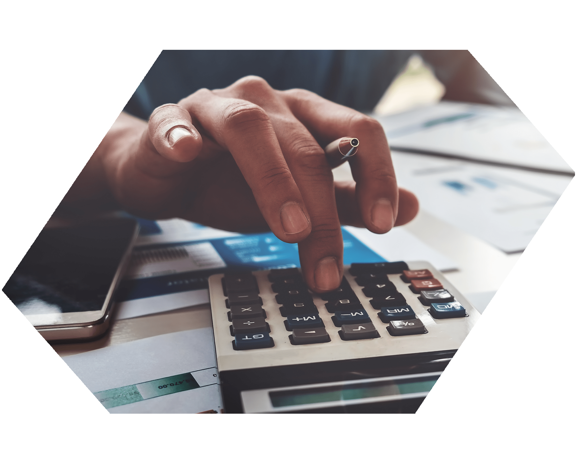 Hand typing on a calculator