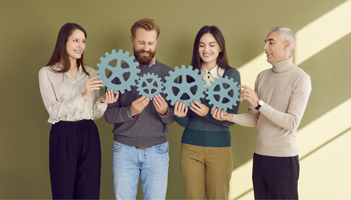 Four people with cogs